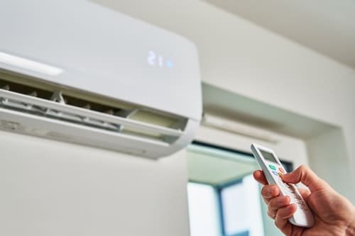adjusting-air-conditioner-temperature-at-home-with-2026-09-24-12-03-47-utc (1)